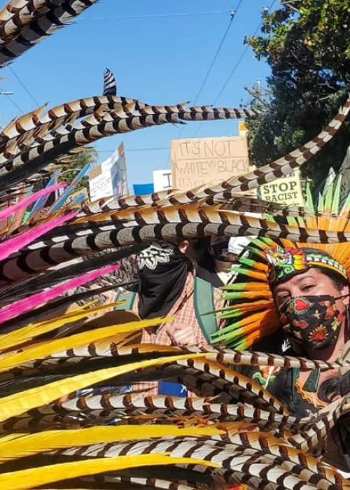 colorful headdress and people marching