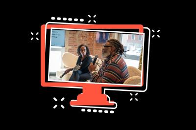 two people in conversation, seated in front of brick wall