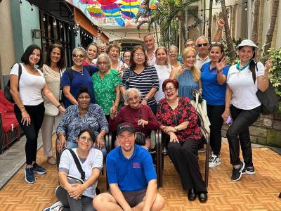 diverse group of 15 people in an lush alley