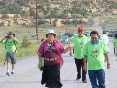 group of people walking on a desert road