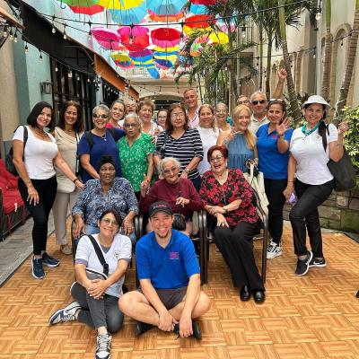 diverse group of 15 people in an lush alley